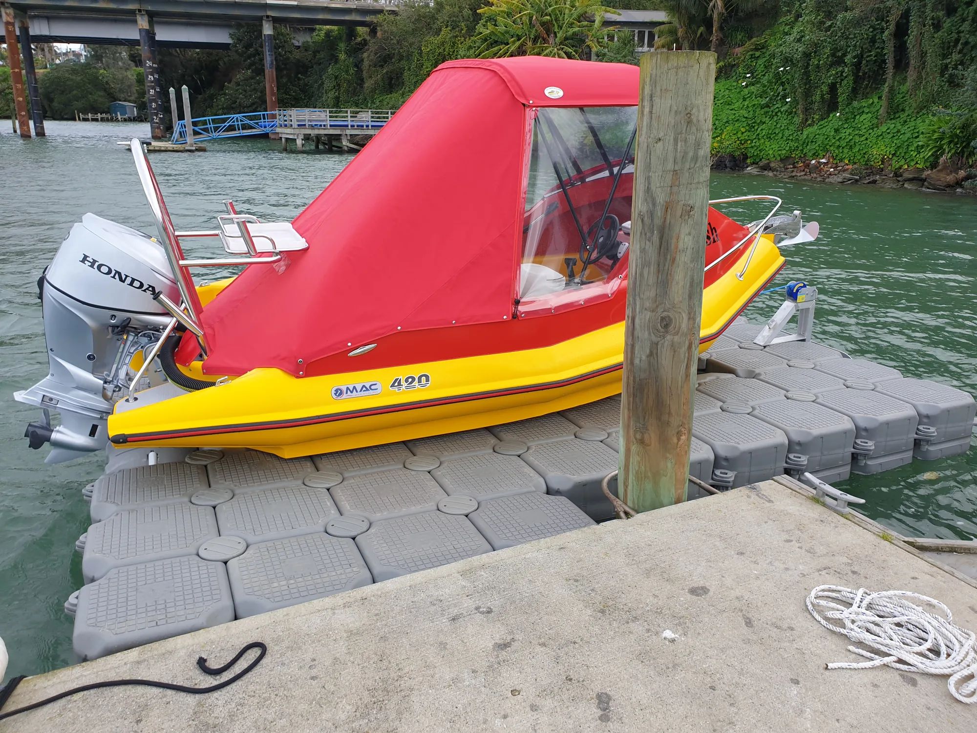 MAC 420 boat with a red canopy on a modular jet dock at Panmure