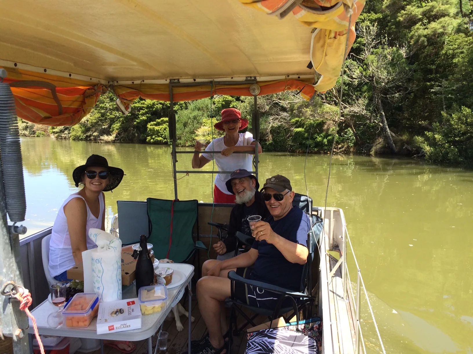 Friends having a picnic under the canopy of a pontoon boat