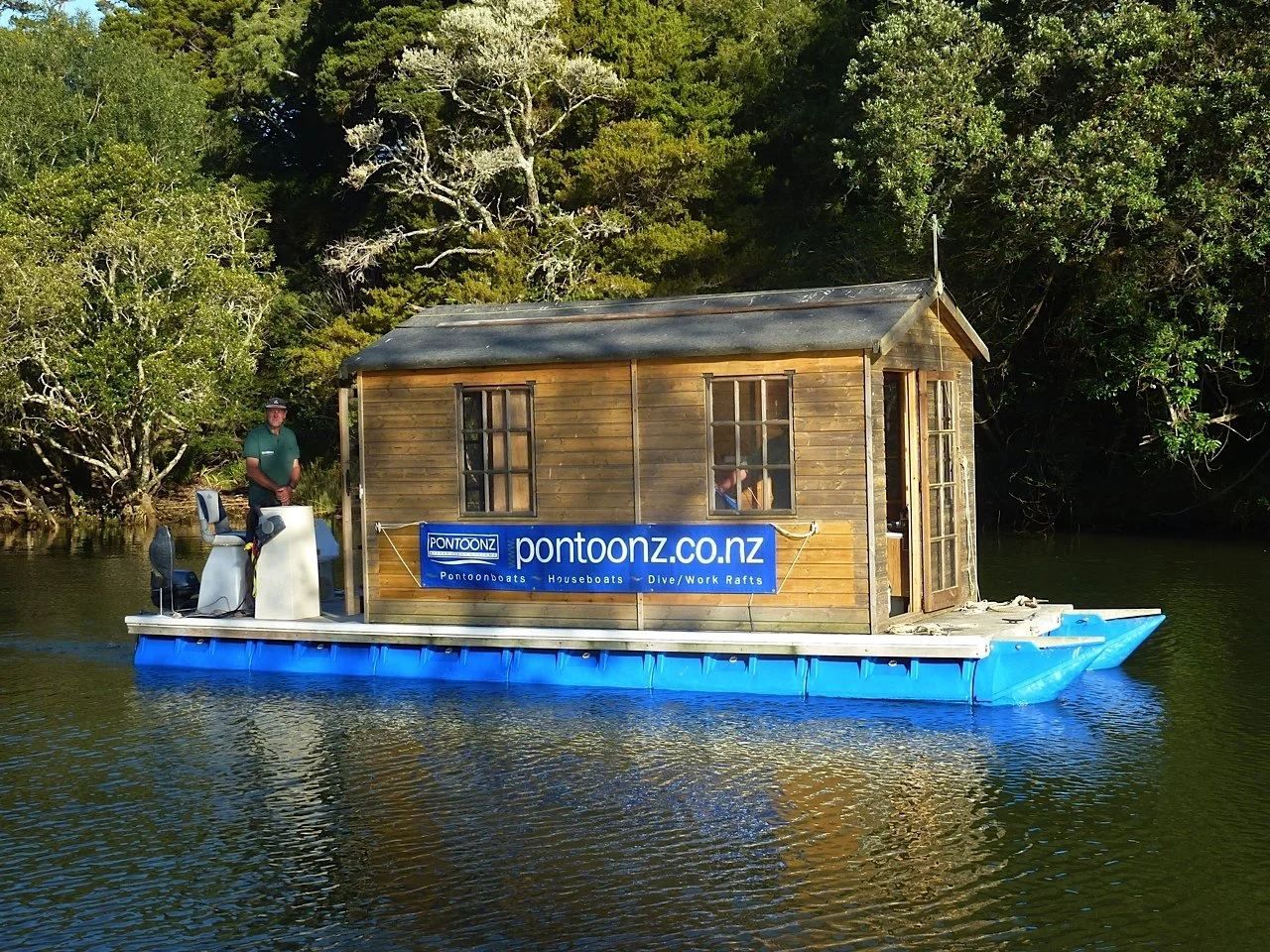 Cedar-clad houseboat moored on an estuary