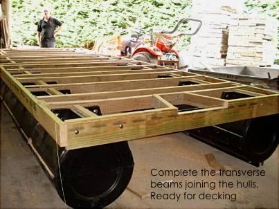 Two pod hulls joined by transverse timber beams, ready for decking