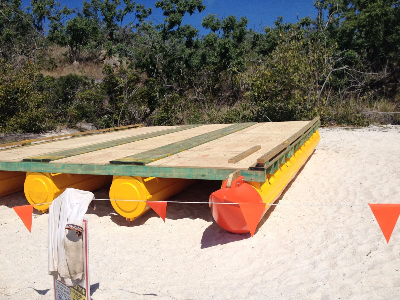 Multi-hull digger barge on a beach