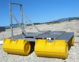 Metal pump platform frame on yellow pods, on gravel