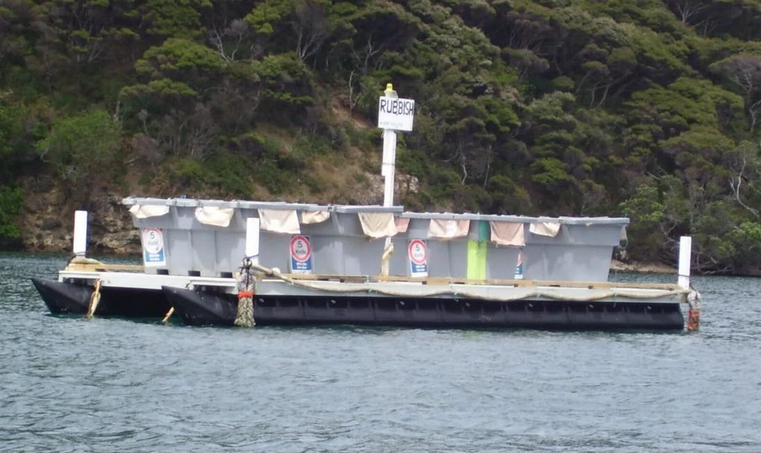 12 metre rubbish barge with bins on deck