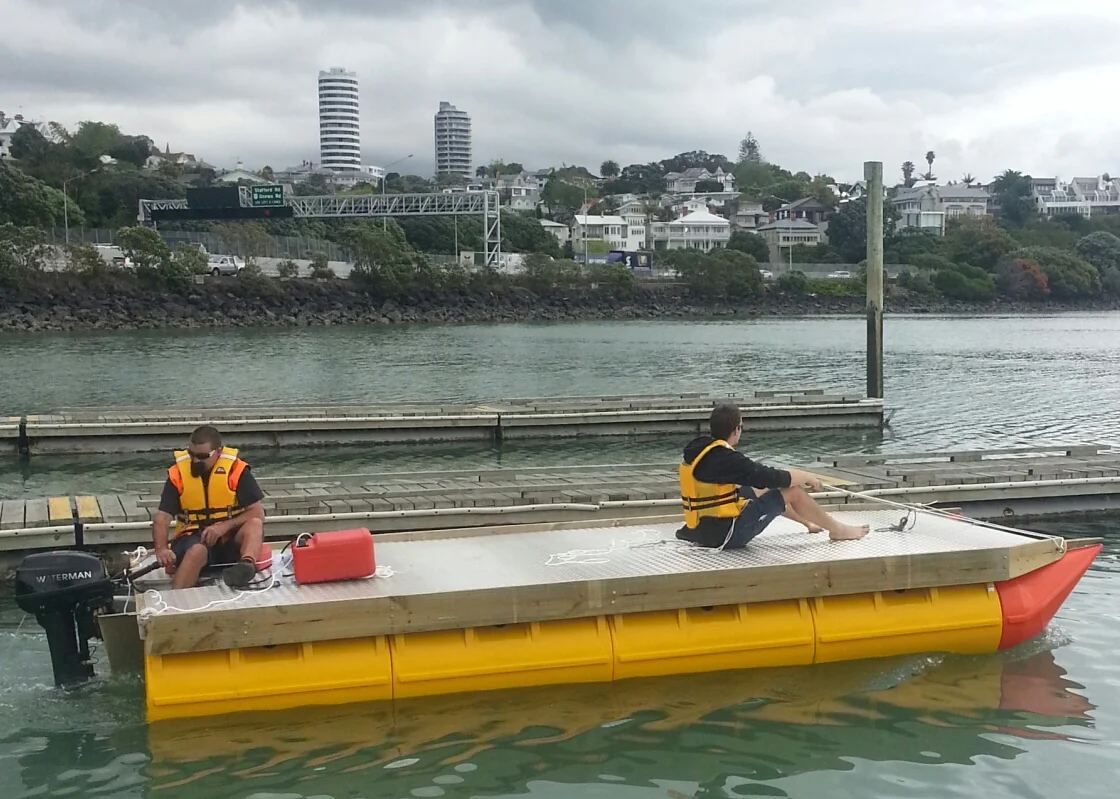 Two people on a yellow utility boat