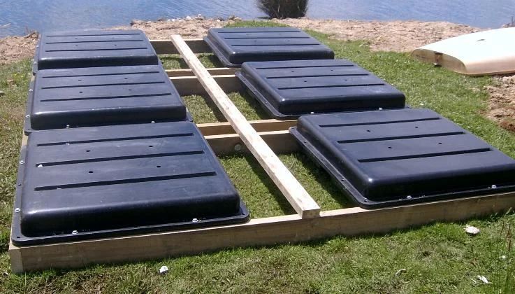 Black Walk Pods laid out either side of a timber walkway frame