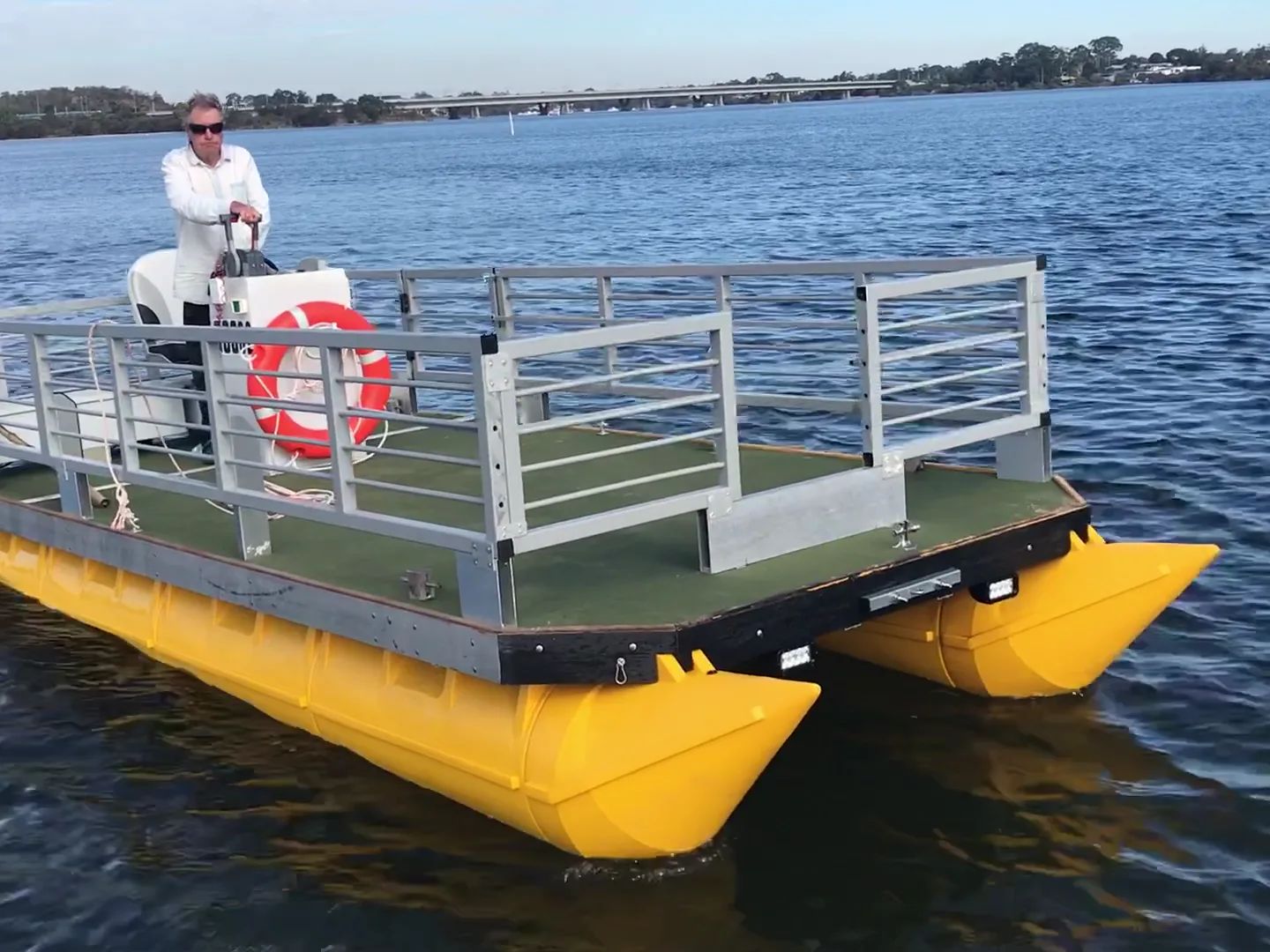 Video: railed pontoon boat on yellow pods driving towards the camera